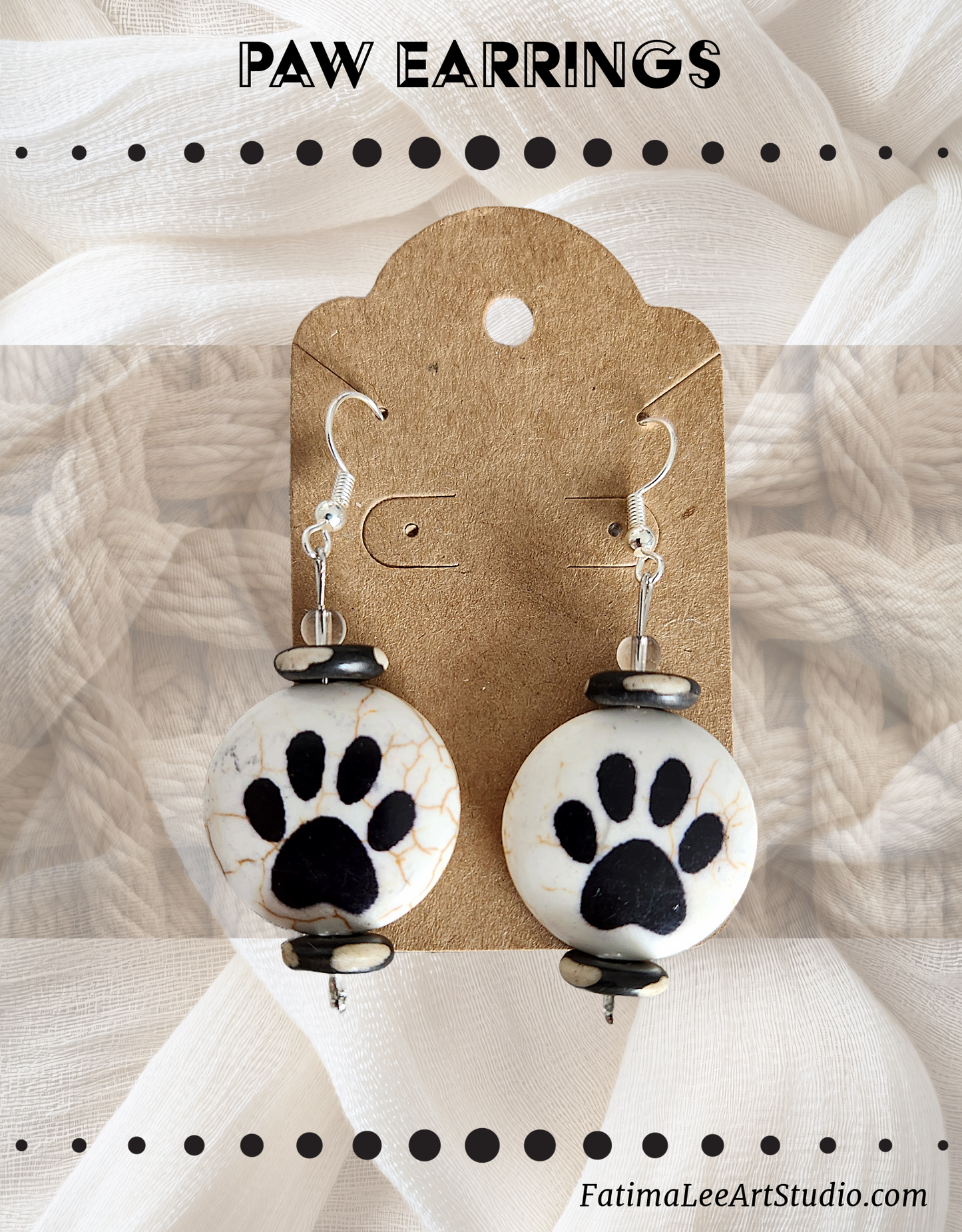 A pair of handmade paw print earrings made from natural stone,