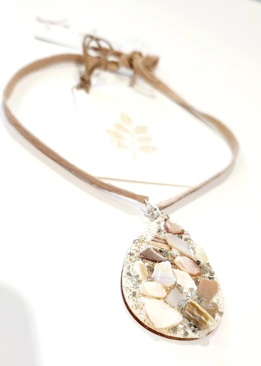 Shell necklace on wooden board with Suede leather