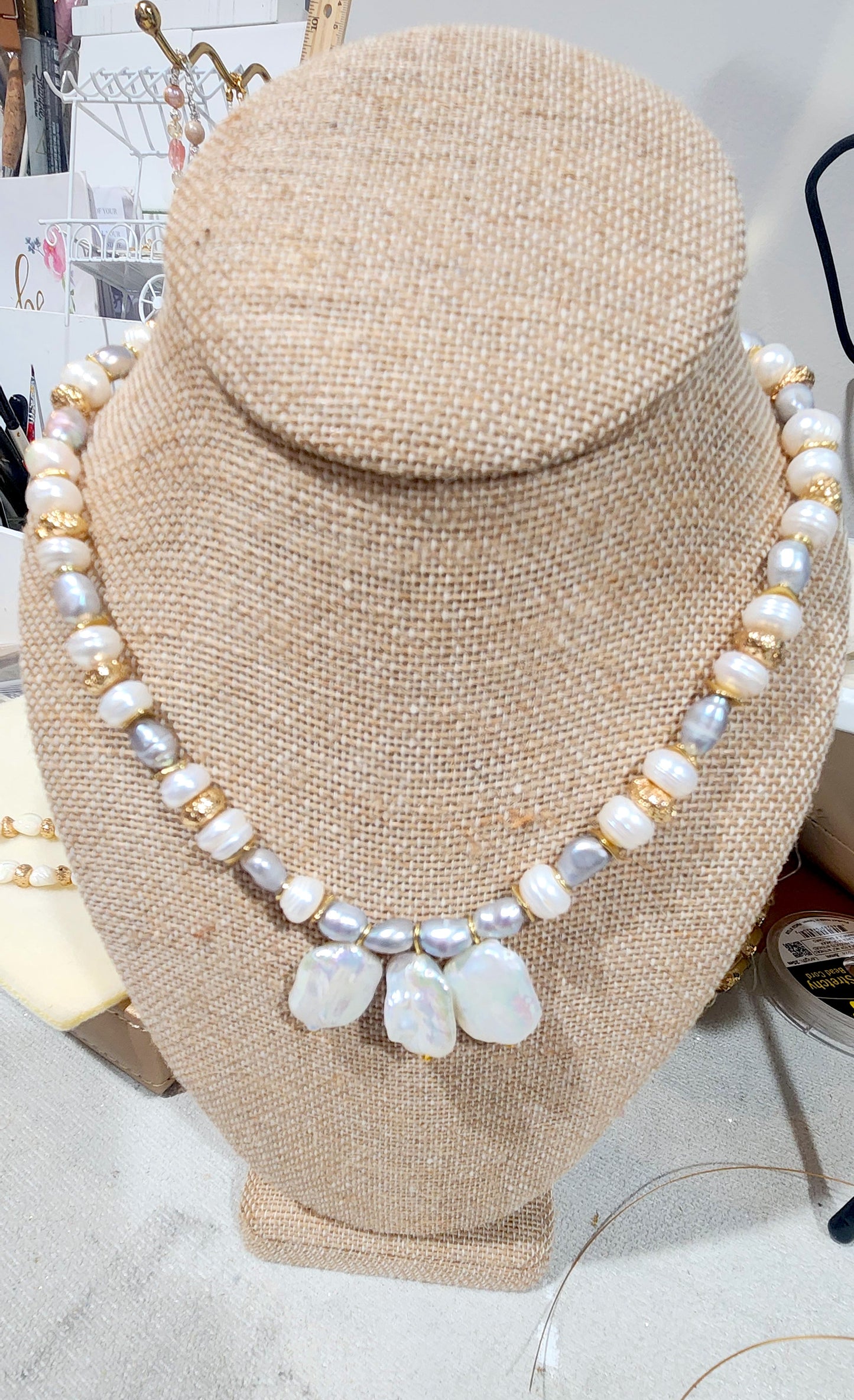 white and gray pearl necklace with gold plated volcano stones